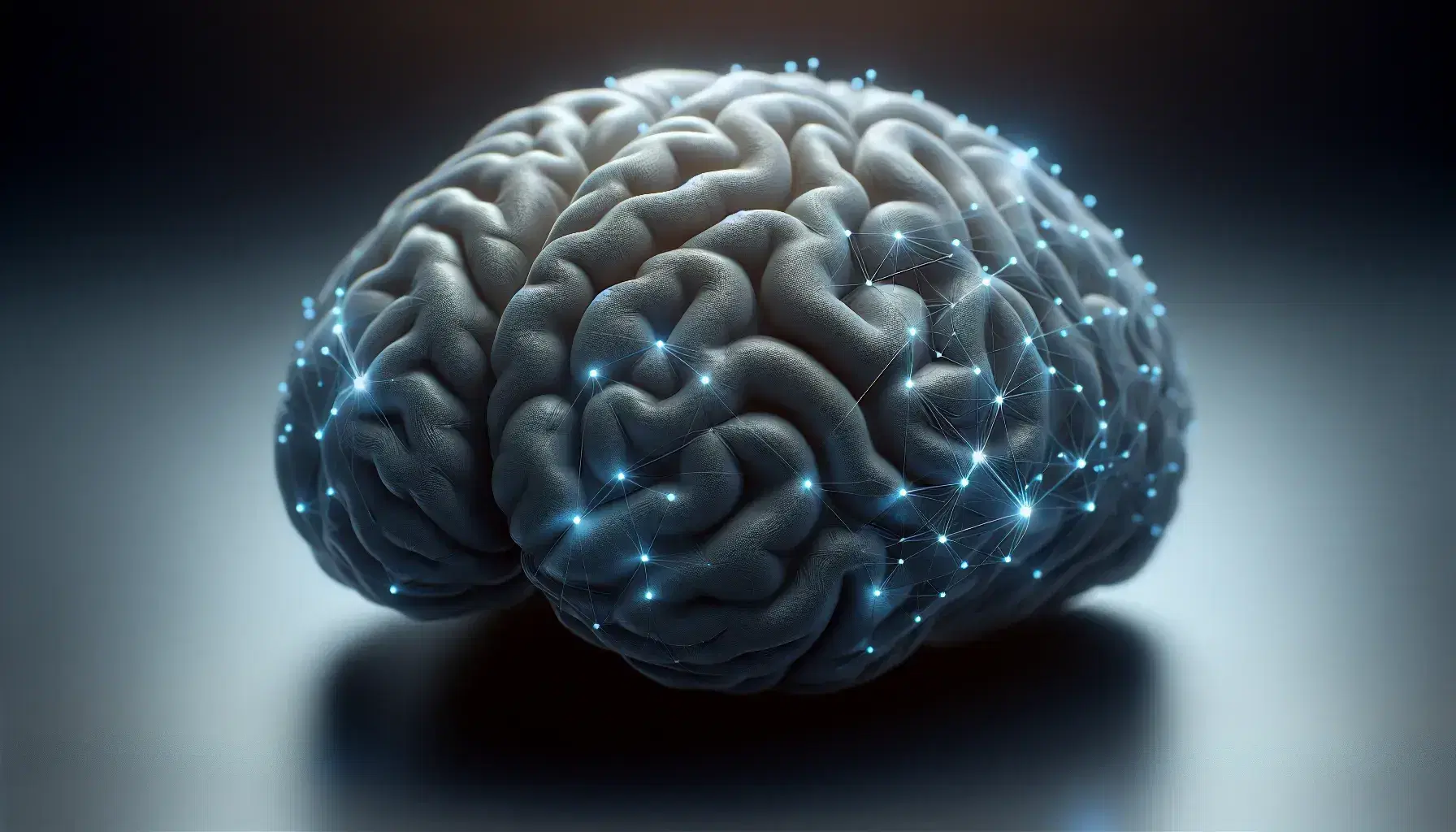 Cerebro humano en tonos grises y azules con red neuronal luminosa en la parte superior destacando sobre fondo oscuro.