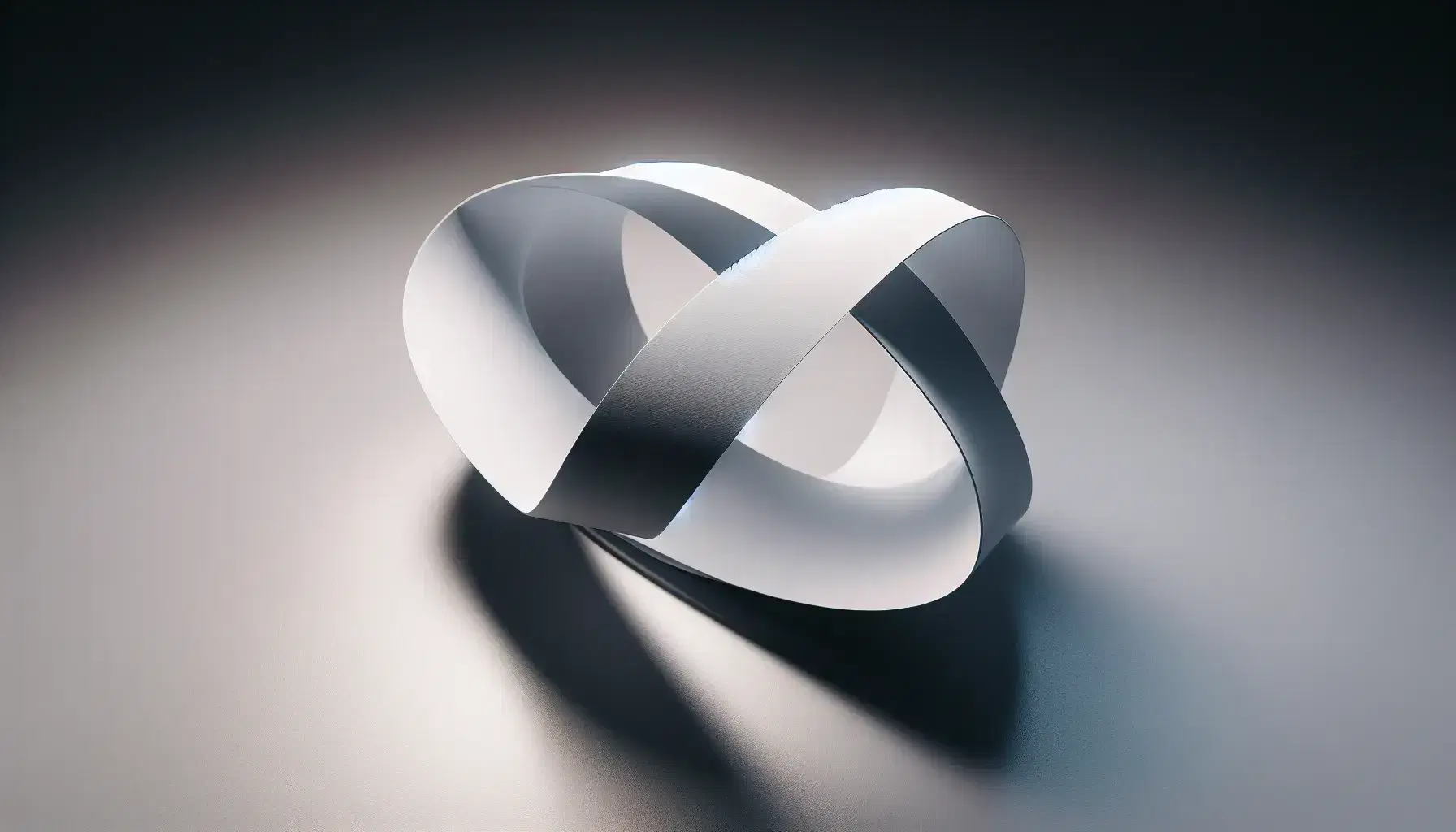 Close-up view of a white Möbius strip with a central twist on a reflective surface against a neutral gray background, highlighting its one-sided topology.