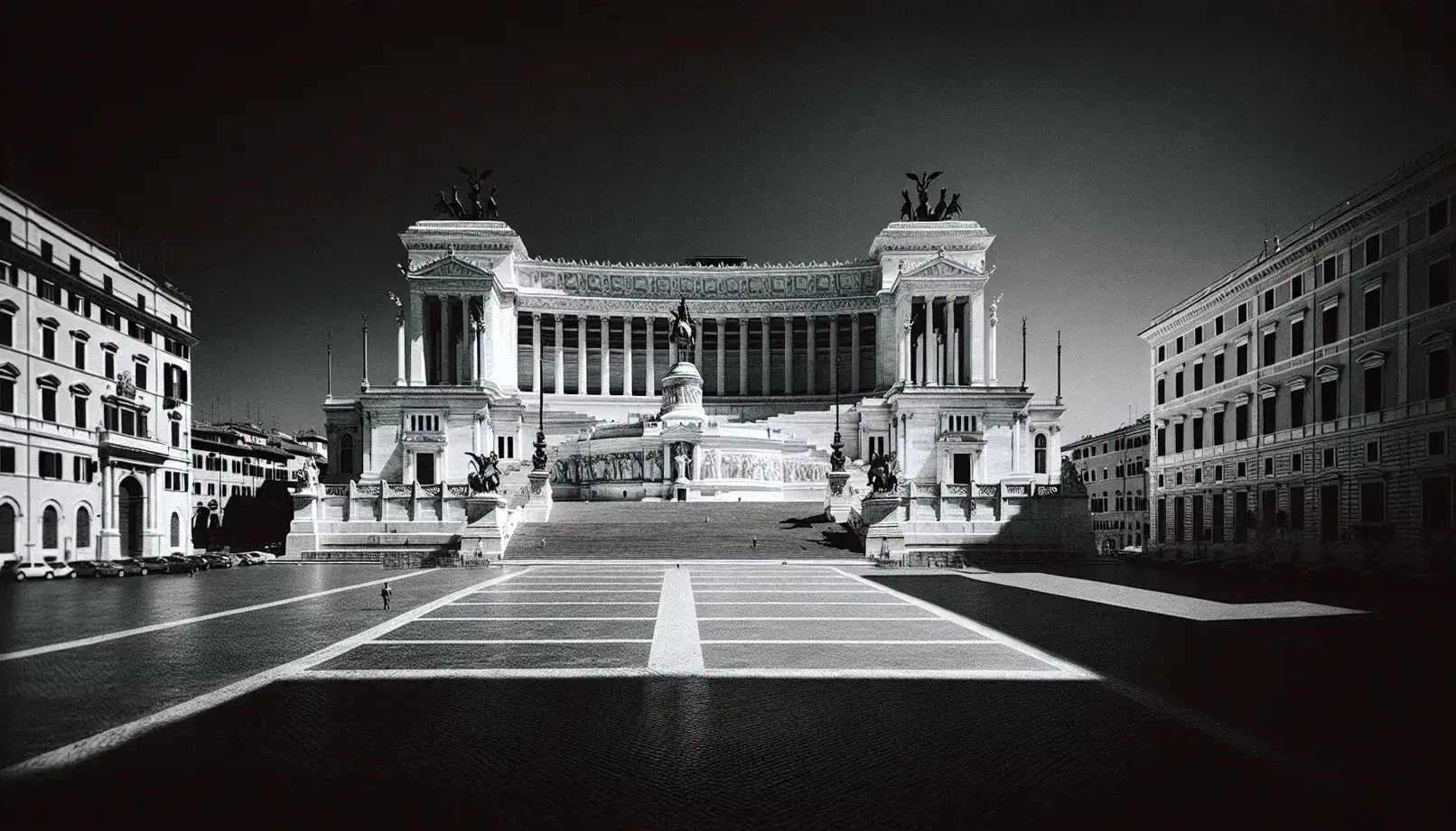 Black and white photo of Rome's Altare della Patria with clear skies, highlighting the monument's marble staircases, columns, and central equestrian statue.