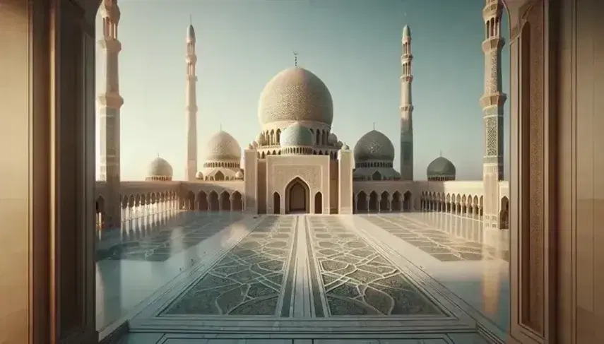 Vista panorámica de una mezquita islámica con gran cúpula beige, cuatro minaretes esbeltos y esplanada de mármol blanco bajo un cielo despejado.
