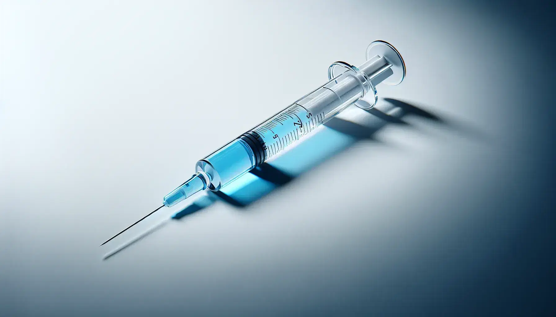 Transparent glass syringe with bright blue liquid, placed horizontally on a white background, with a protective cap and light shadow.