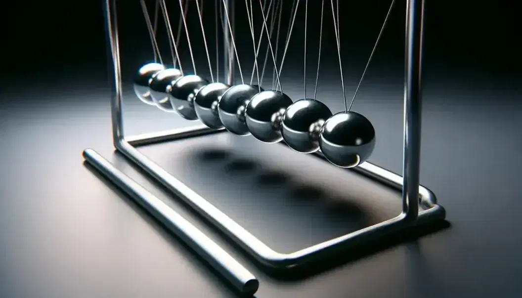 Newton's cradle with one silver ball pulled back, poised to strike stationary spheres, against a dark background, highlighting potential kinetic energy.